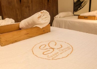 Relaxing massage table setup at SUSAN CHANEL BEAUTY SKINLINE - ALLEN in Ikeja, Lagos, NG with branded linens.