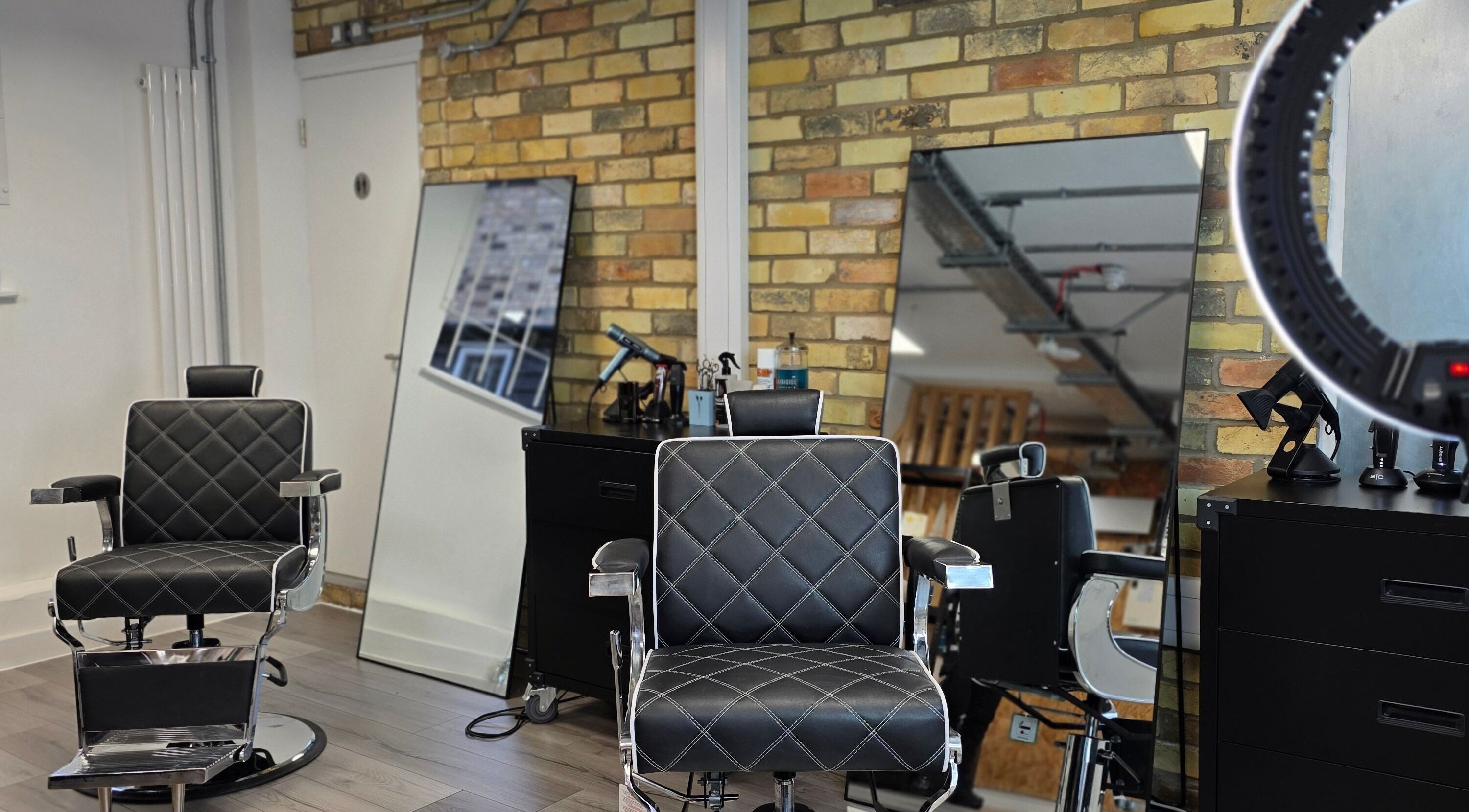 Modern salon chairs at Studio19 in Cambridge, England, GB with sleek mirrors and stylish decor.