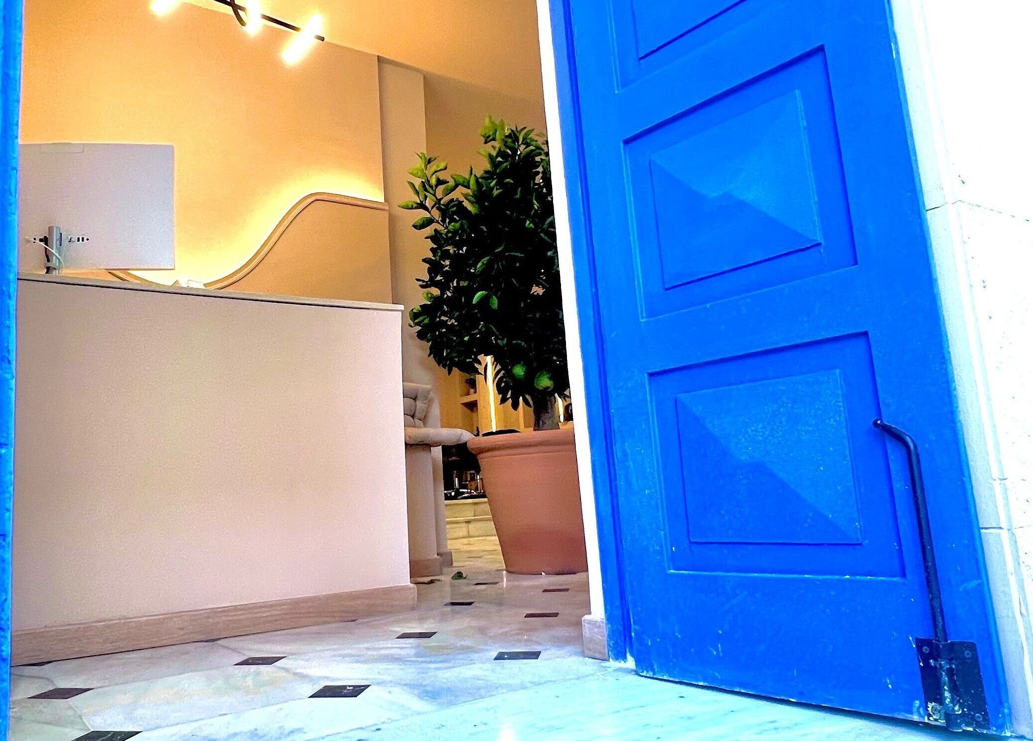 Bright blue door opens into Umeo Marbella, a serene beauty venue in Marbella, Andalucía, ES.