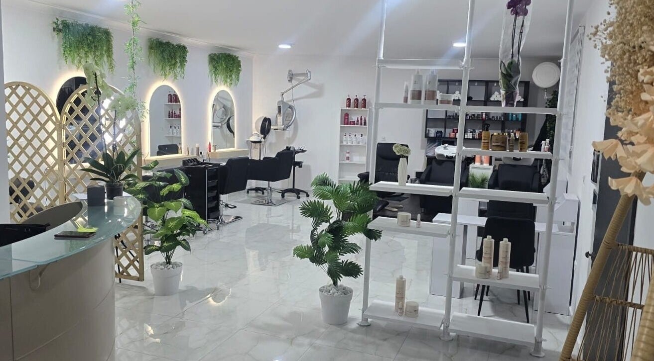 Chic, modern salon interior at MyRio Beauty in Birkirkara, MT with stylish furnishings and vibrant greenery.