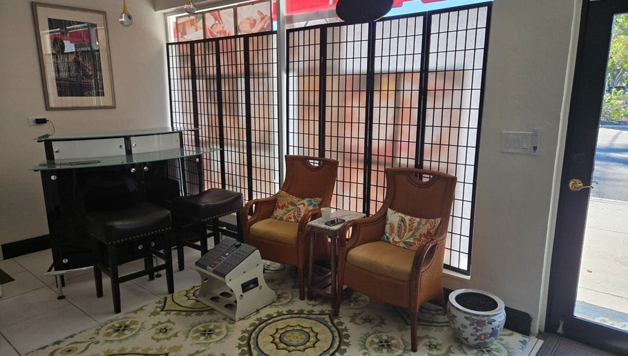 Cozy seating area at K Day Spa, Naples, Florida, US with elegant chairs and decorative accents.