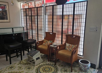 Cozy seating area at K Day Spa, Naples, Florida, US with elegant chairs and decorative accents.