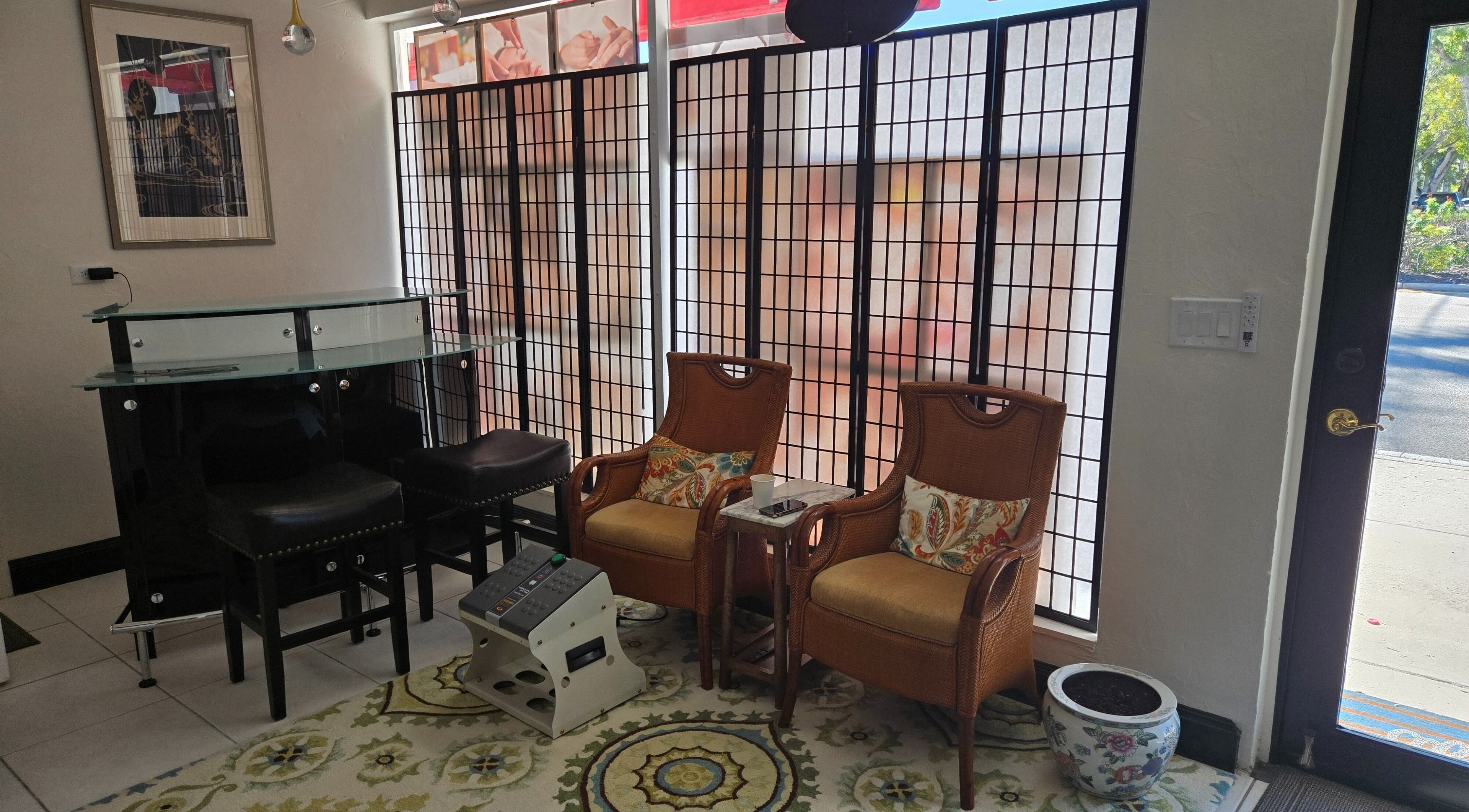 Cozy seating area at K Day Spa, Naples, Florida, US with elegant chairs and decorative accents.
