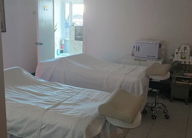 Relaxing massage room at K Day Spa, Naples, Florida, US with treatment beds and soothing ambiance.