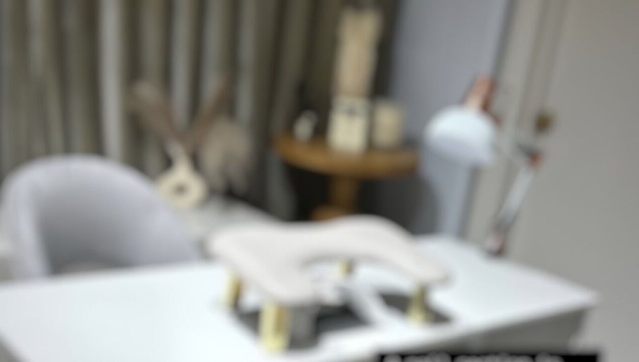 Stylish nail treatment area at Khristi Nails, London, England, GB, featuring a modern chair and table.