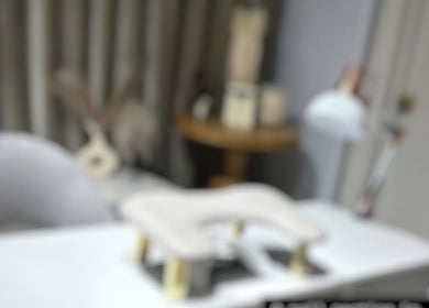 Stylish nail treatment area at Khristi Nails, London, England, GB, featuring a modern chair and table.