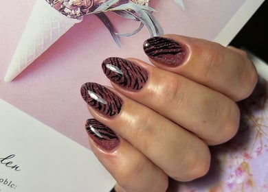 Stylish zebra print nail art by Khristi nails in London, England, GB. Bold, trendy manicure design.