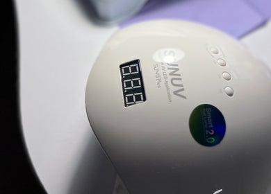 UV nail lamp device at Khristi nails, London, England, GB, showcasing modern manicure technology.