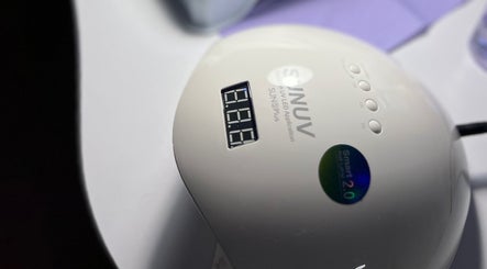 UV nail lamp device at Khristi nails, London, England, GB, showcasing modern manicure technology.