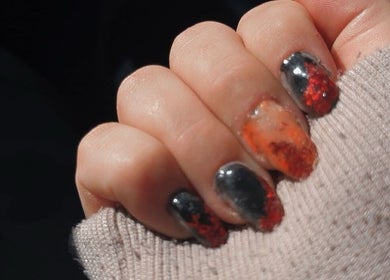Orange and black nail art at BADDIE ERA STUDIO in Québec, Québec, CA.