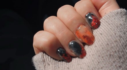 Orange and black nail art at BADDIE ERA STUDIO in Québec, Québec, CA.