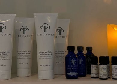 Luxury skincare products on display at Emily - Skin Rest Results, Sheffield, England, GB, beside a calming candle.