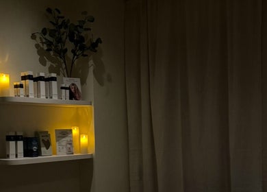 Calming candlelit shelves at Emily - Skin Rest Results, Sheffield, England, GB, showcasing beauty products.