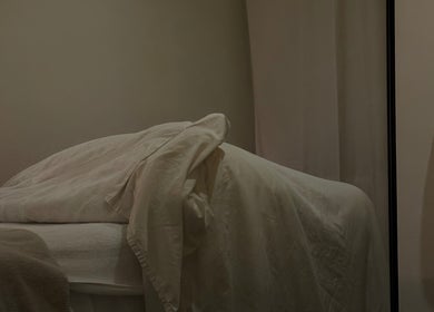 Tranquil massage room with beige linens at Emily - Skin Rest Results, Sheffield, England, GB.