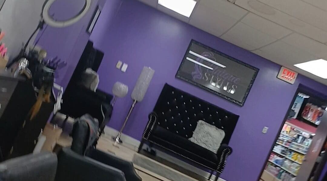 Stylish, modern interior of Acyileez Truth in Nashville, Tennessee, US with purple walls and elegant seating.