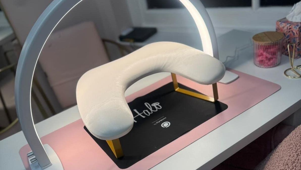 Stylish nail station at Swan Elegance Beauty, Kimberley, England, GB, featuring a Halo lamp and comfort cushion.