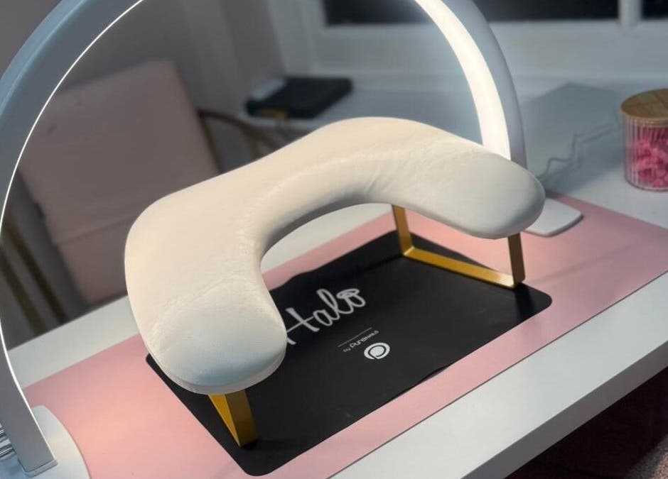 Stylish nail station at Swan Elegance Beauty, Kimberley, England, GB, featuring a Halo lamp and comfort cushion.