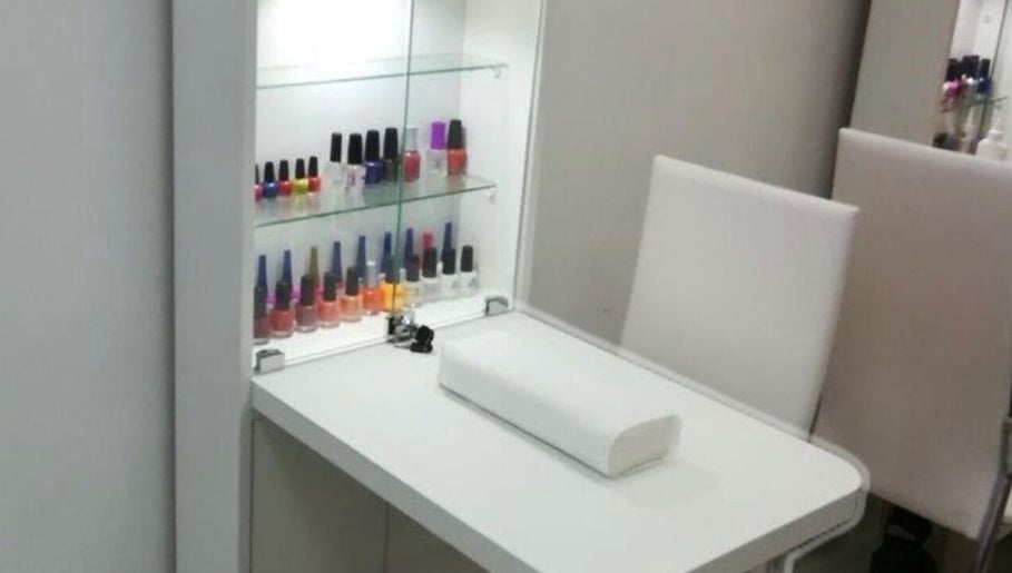 Elegant nail bar at JPOSH, Portmore, St. Catherine Parish, JM, featuring polish display and sleek seating.