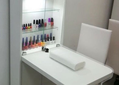 Elegant nail bar at JPOSH, Portmore, St. Catherine Parish, JM, featuring polish display and sleek seating.
