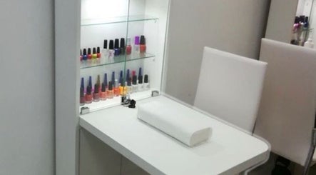 Elegant nail bar at JPOSH, Portmore, St. Catherine Parish, JM, featuring polish display and sleek seating.