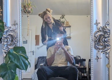 Reflective hairstyling session at Foxglove Beauty in Radcliffe, England, GB, elegant mirror interior.