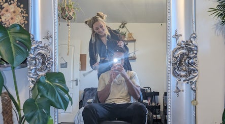 Reflective hairstyling session at Foxglove Beauty in Radcliffe, England, GB, elegant mirror interior.