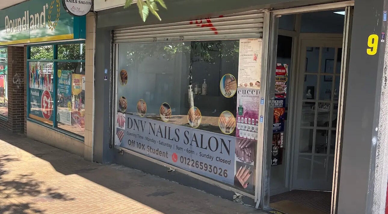 Entrance of DNV NAILS SALON, Barnsley, England, GB with signage offering 10% student discount.