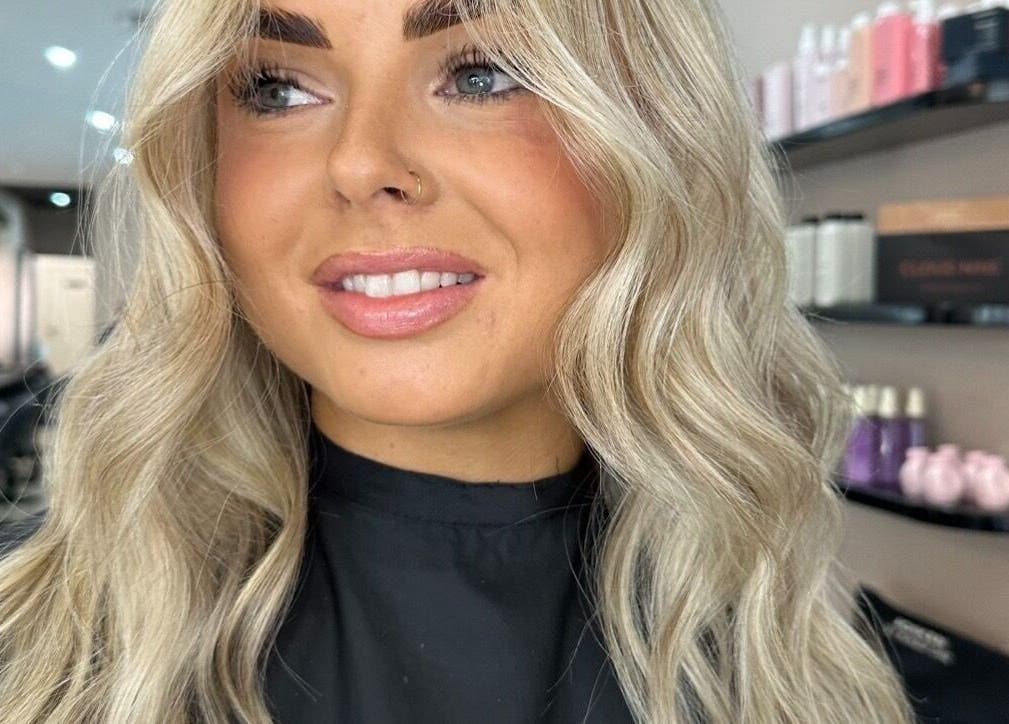 Smiling client with styled blonde hair at Runway salon, Tamworth, New South Wales, AU.
