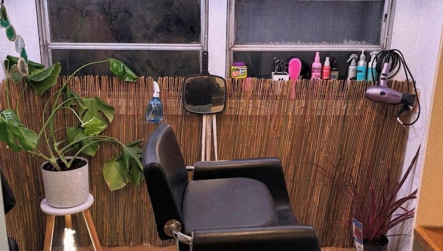 Trendy salon chair at Hopes 4 Hair, Melbourne, Victoria, AU, with plants and styling tools.