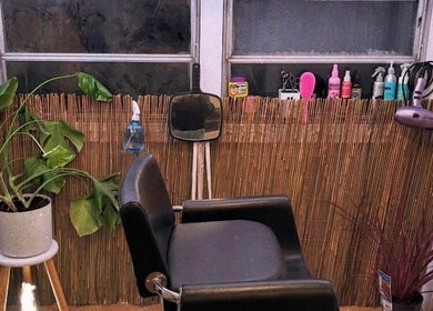 Trendy salon chair at Hopes 4 Hair, Melbourne, Victoria, AU, with plants and styling tools.