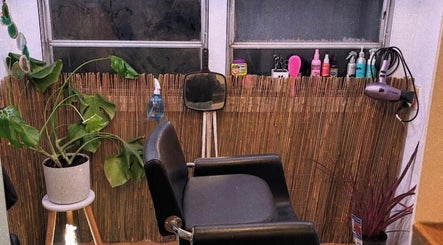 Trendy salon chair at Hopes 4 Hair, Melbourne, Victoria, AU, with plants and styling tools.