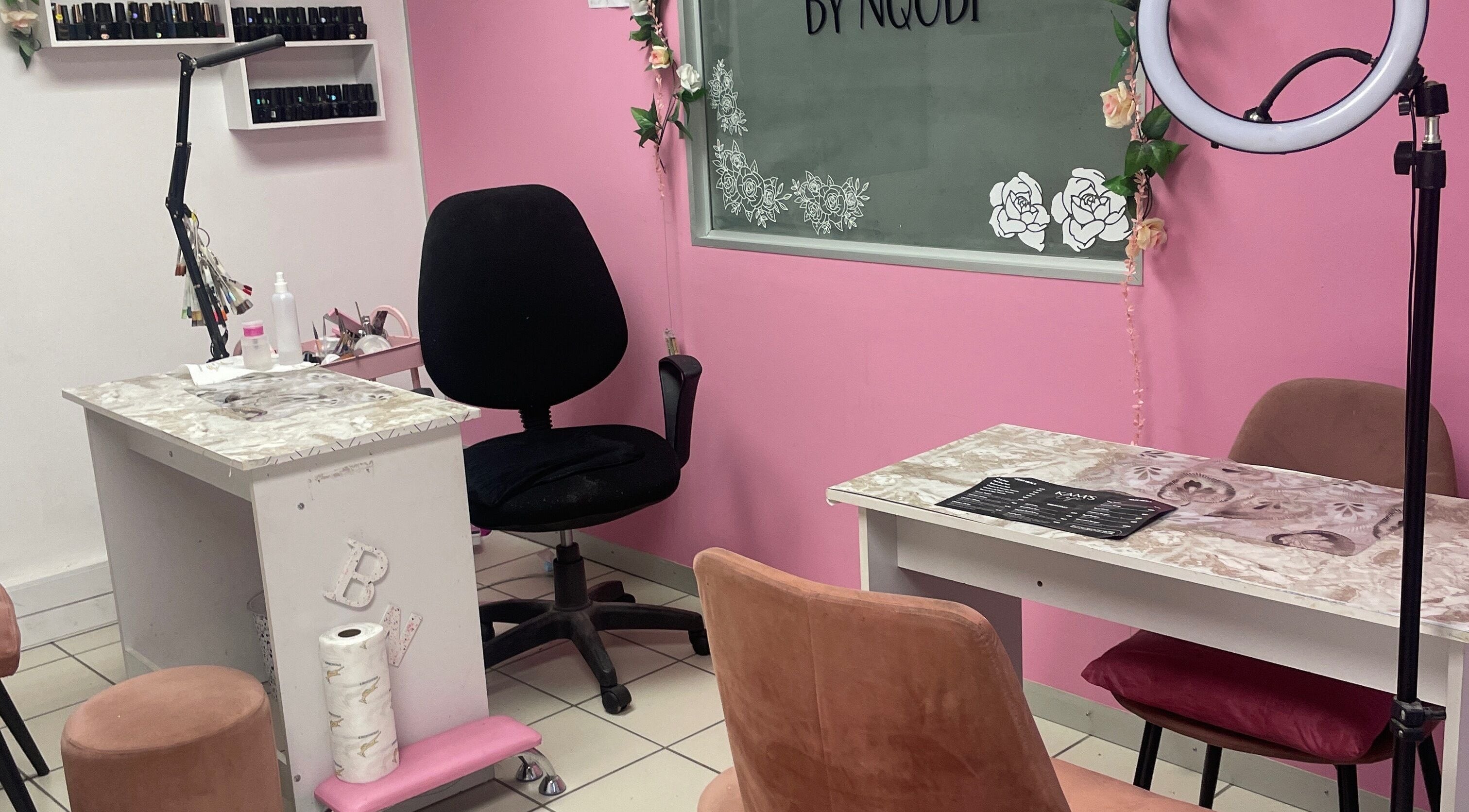 Chic interior of Brushed Nails by Nqobi, Johannesburg, Gauteng, ZA showcasing pink walls and nail stations.