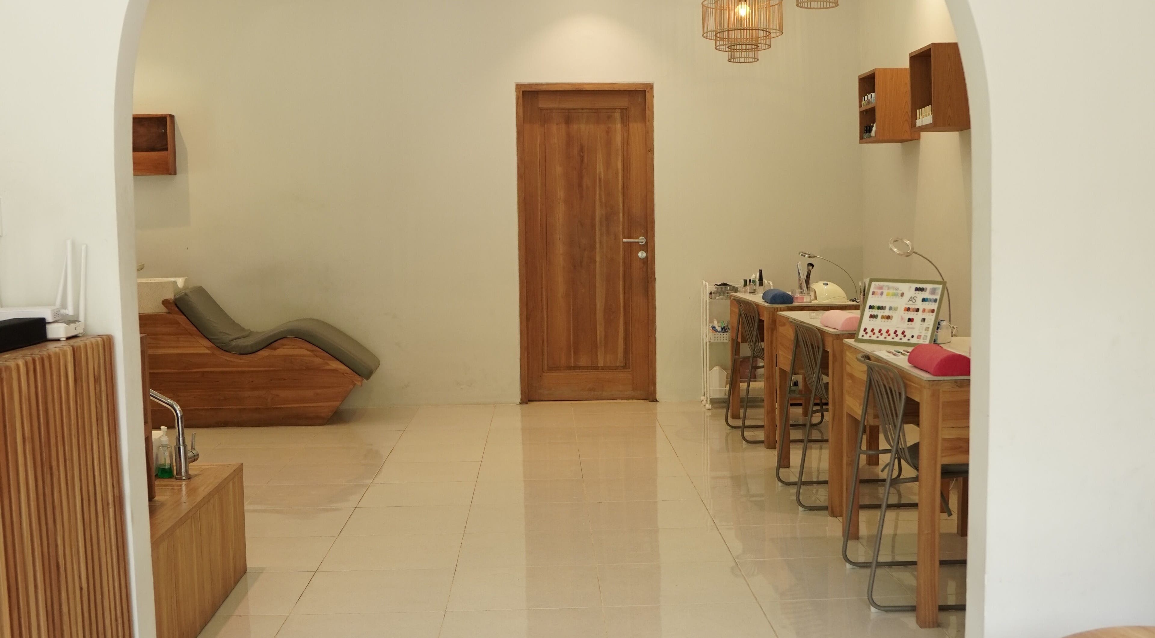 Modern nail and relaxation area at KU Salon & Spa, Nusa Tenggara Barat, with chic wood accents.