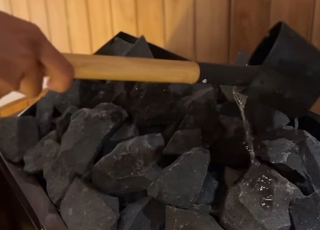 Experience soothing steam therapy at KU Salon & Spa, Nusa Tenggara Barat, ID, with water poured on hot stones.