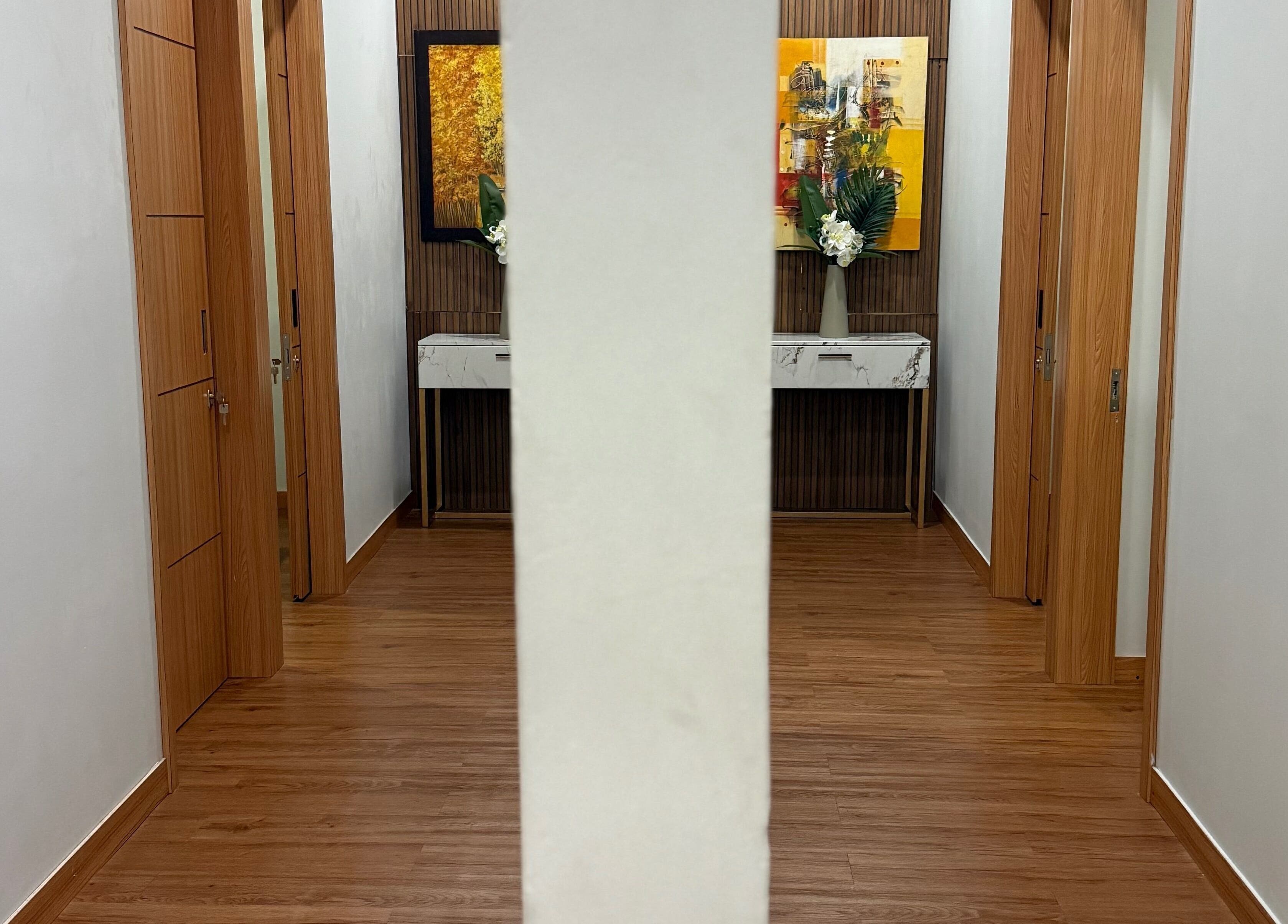 Elegantly decorated hallway at My Spa Lombok Group, Nusa Tenggara Barat, ID with art and floral accents.