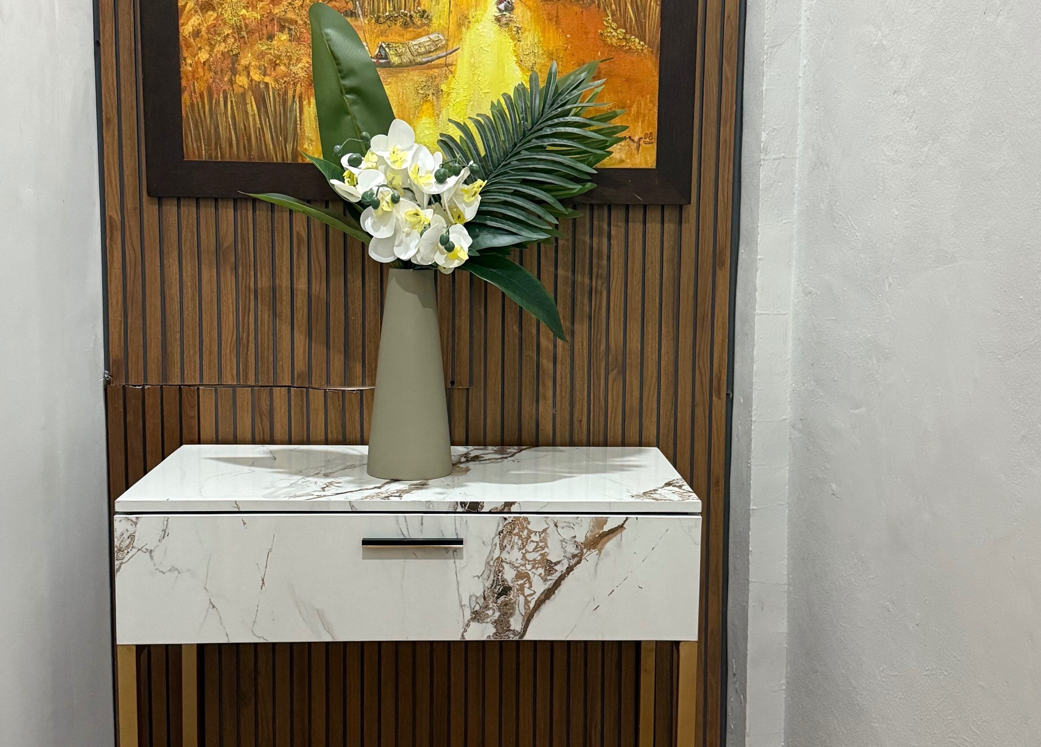 Sleek marble table with floral vase at My Spa Lombok Group in Nusa Tenggara Barat, Nusa Tenggara Barat, ID.