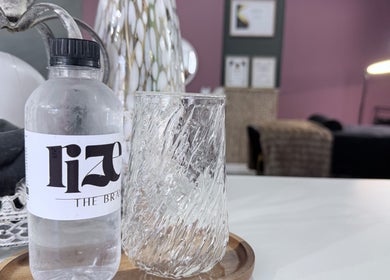 RIZE - The Brand water bottle and glass at Bloemfontein, Free State, ZA, showcasing elegant spa decor.