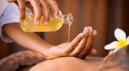 Luxury massage oil poured into hand at Bee Cave Massage, Austin, Texas, US for a relaxing spa experience.