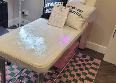 Comfortable treatment bed at Willow Ink in York, England, GB, with inviting pillows and stylish decor.
