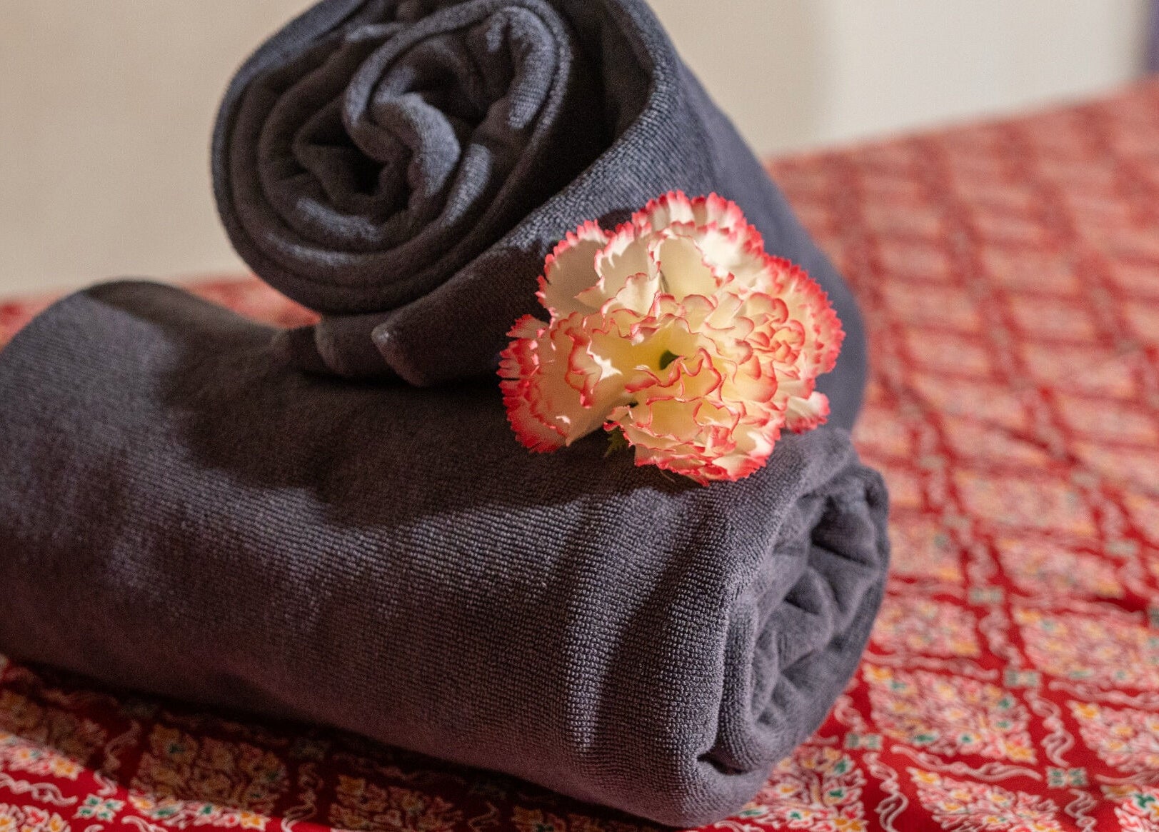 Rolled towels with a flower at Thai Time Wellness Spa, Singapore, Singapore, SG for a relaxing experience.