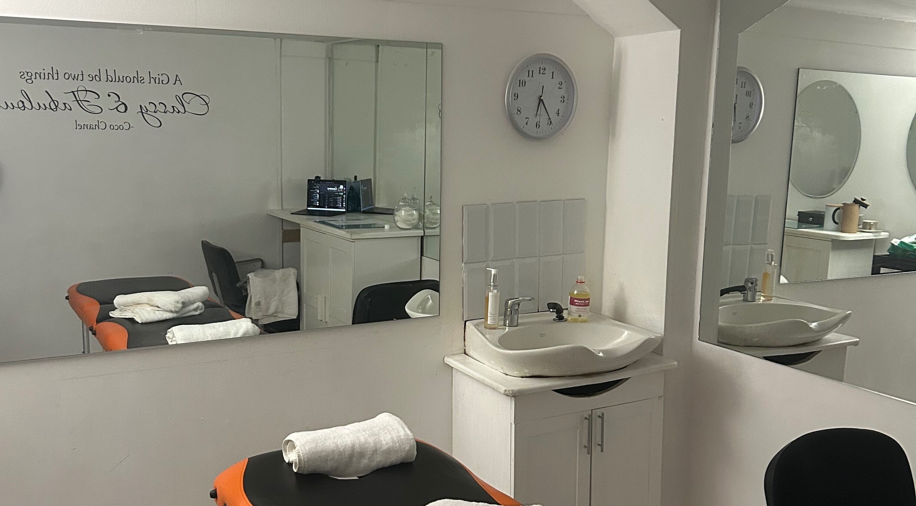 Massage room at Active Revive in Sheffield, England, GB with mirrors, a sink, and treatment table.