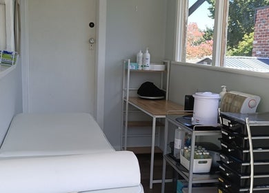 Cozy treatment room at Velvet Waxing and Beauty, Melbourne, Victoria, AU, featuring a massage table and products.