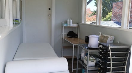 Cozy treatment room at Velvet Waxing and Beauty, Melbourne, Victoria, AU, featuring a massage table and products.