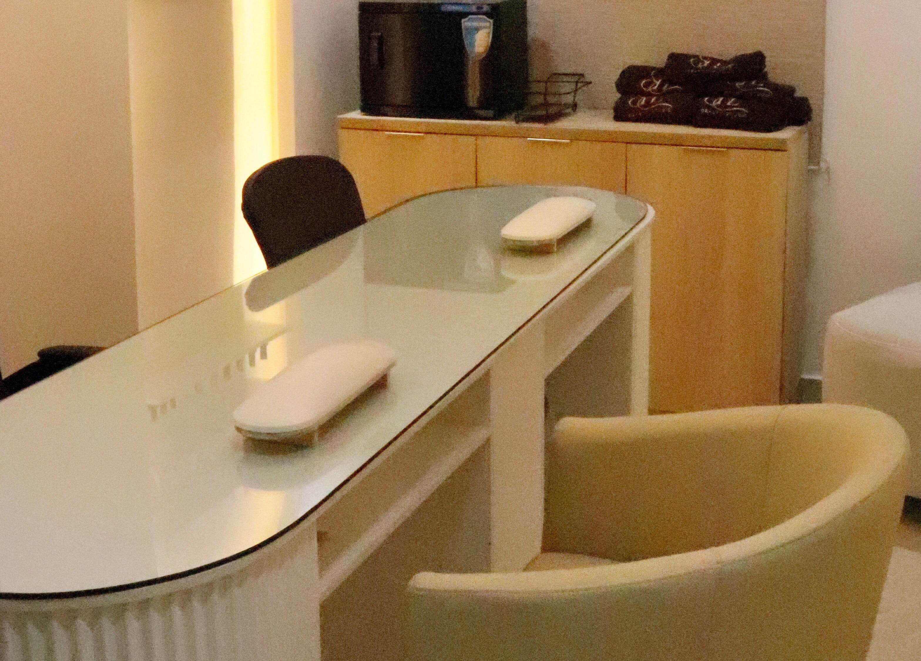 Cozy nail care setup at SHE Beauty Studio, Lagos, Lagos, NG with modern decor and comfy seating.