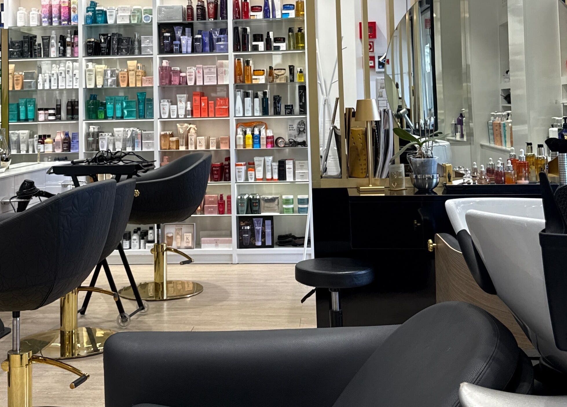 Elegant salon chairs and product shelves at Ton Silva Hair Concept, Parede, Lisboa, PT.
