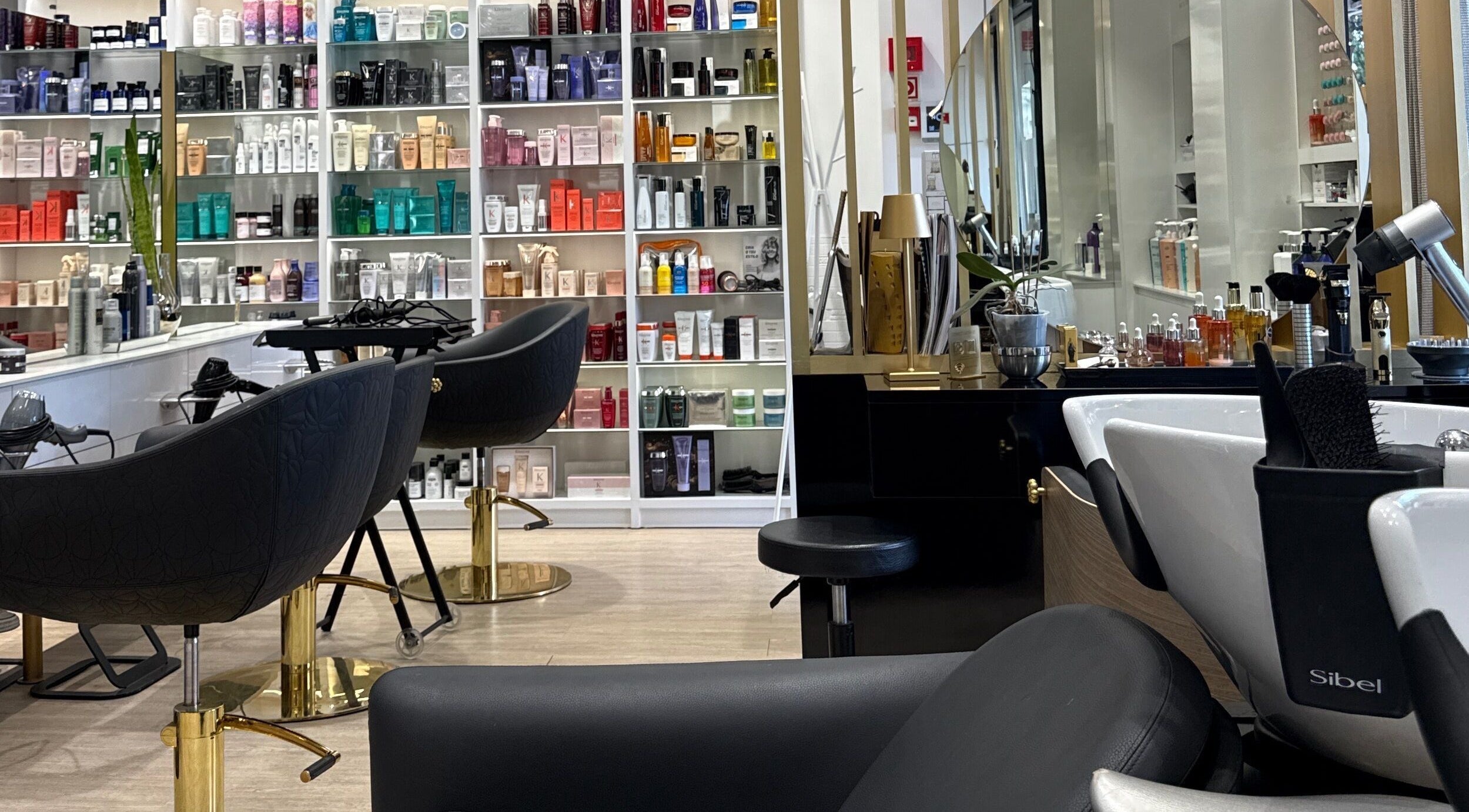Elegant salon chairs and product shelves at Ton Silva Hair Concept, Parede, Lisboa, PT.