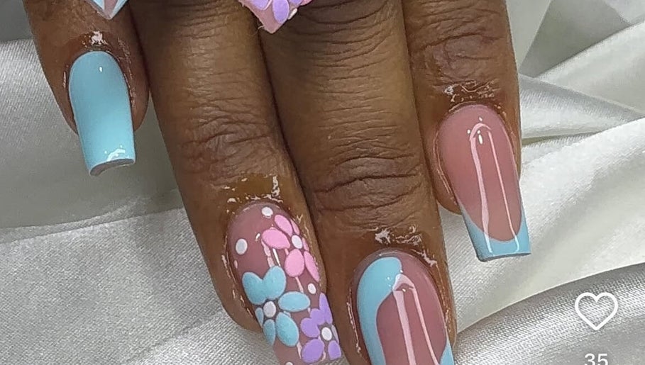 Floral nail art with blue accents at Tertia’s nail bar, Johannesburg, Gauteng, ZA.