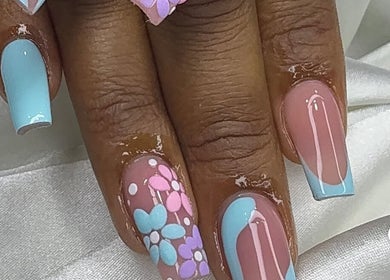 Floral nail art with blue accents at Tertia’s nail bar, Johannesburg, Gauteng, ZA.