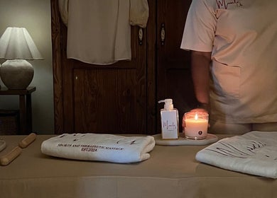 Calming massage setup at Home Services, Al Hayathem, Riyadh Province, SA with candles and therapeutic oils.