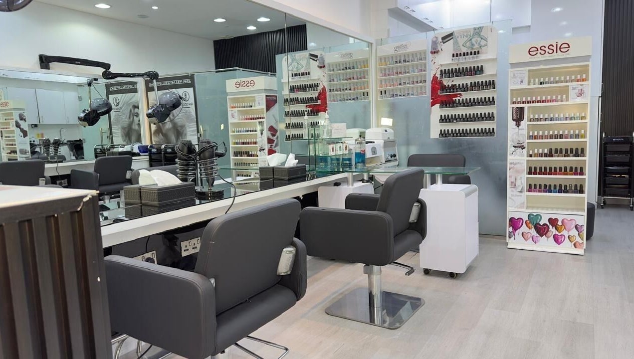 Modern interior of Lya Arabi Beauty Salon in Dubai, AE with nail polish displays and styling chairs.